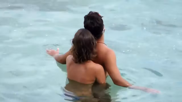 Topless GF captured when giving handjob in the water