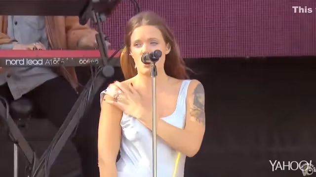 Attractive inked singer shows off one of her tits at a show