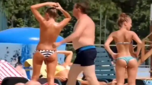 Topless skinny girl looks sexy at the water park