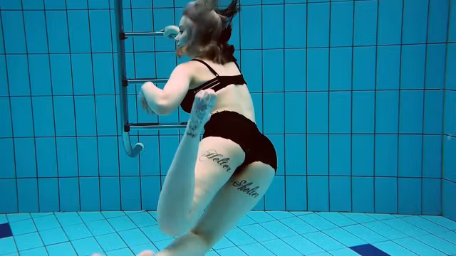 Tattooed baby swirls underwater