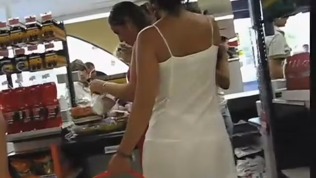 Thong peeks through her white dress