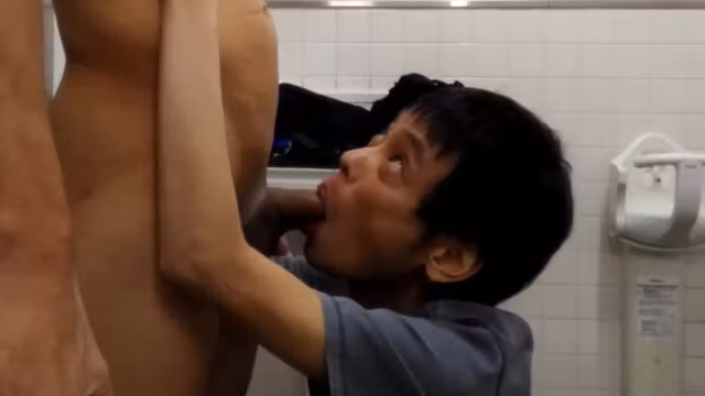 Japanese gay helping friend to cum in the public bathroom