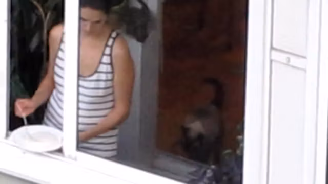 sexy bird in the window making cereal wearing a thong
