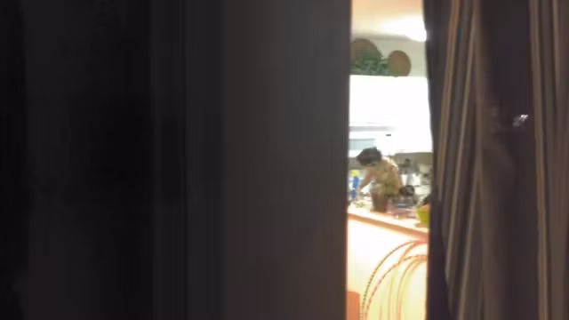 Girl in the window is sitting naked on the sofa