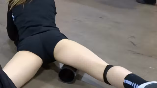 Sporty girl stretches right in front of me