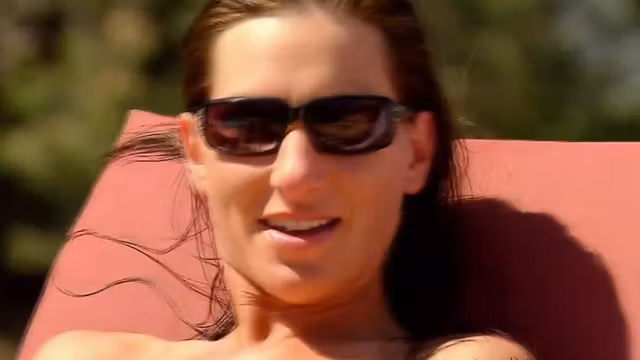 Horny swingers are sunbathing naked during pool party.