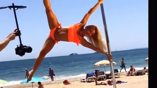 Blonde lass doing her pole dancing show